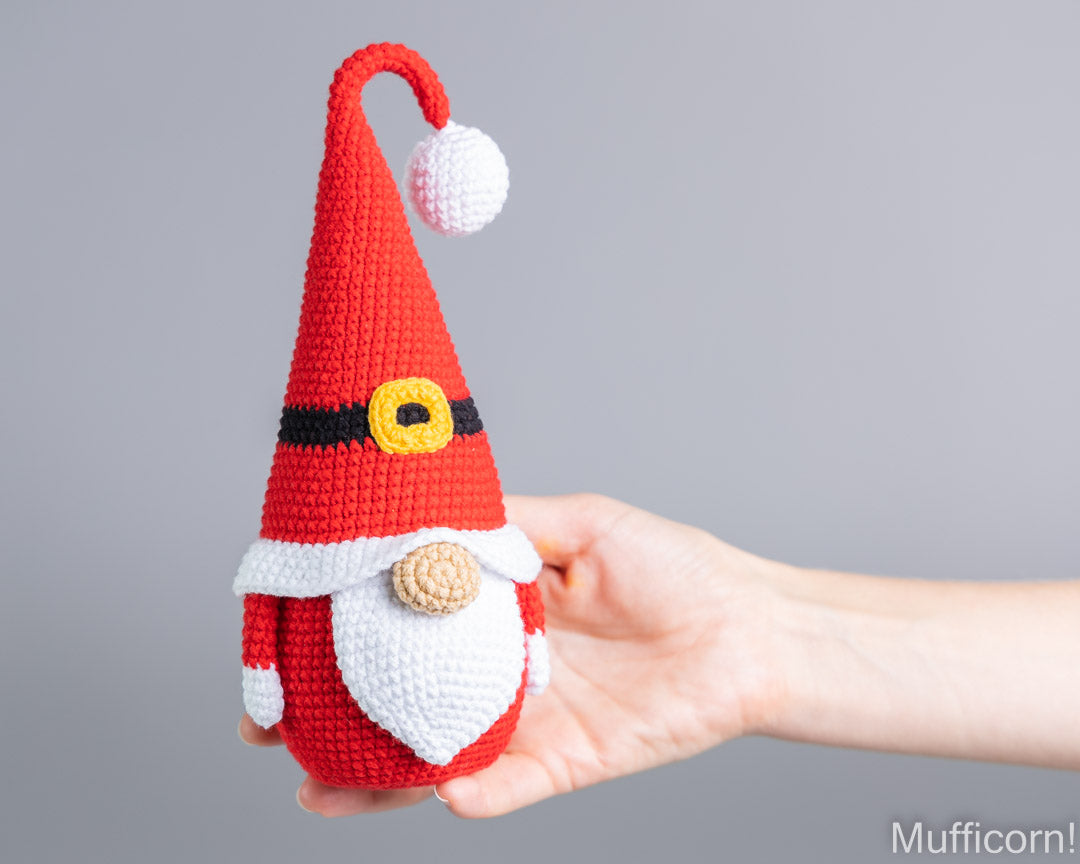 Crochet Mr Santa gnome amigurumi held in hand