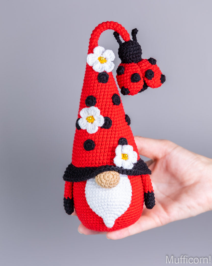 Crochet ladybug gnome held in hand