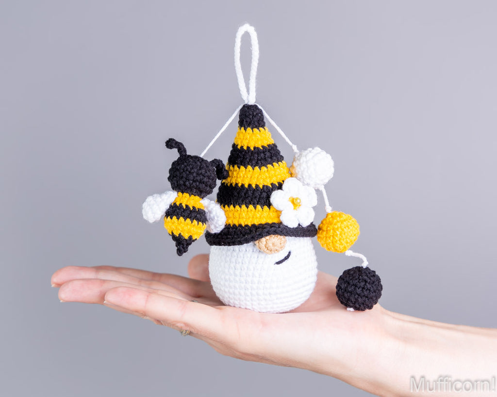 Crochet bee gnome keychain standing on hand