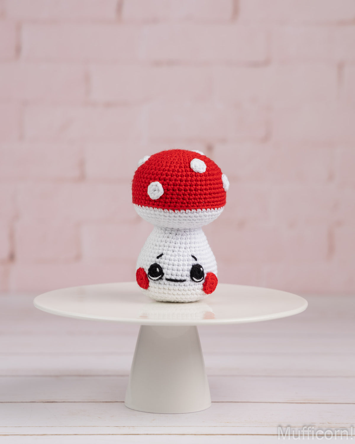 Crochet mushroom baby amigurumi standing on tray