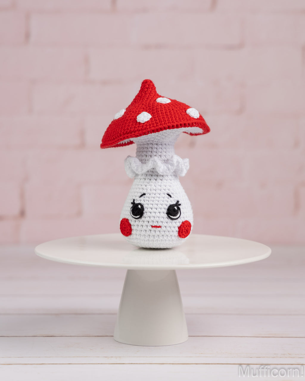 Crochet mushroom girl amigurumi standing on tray