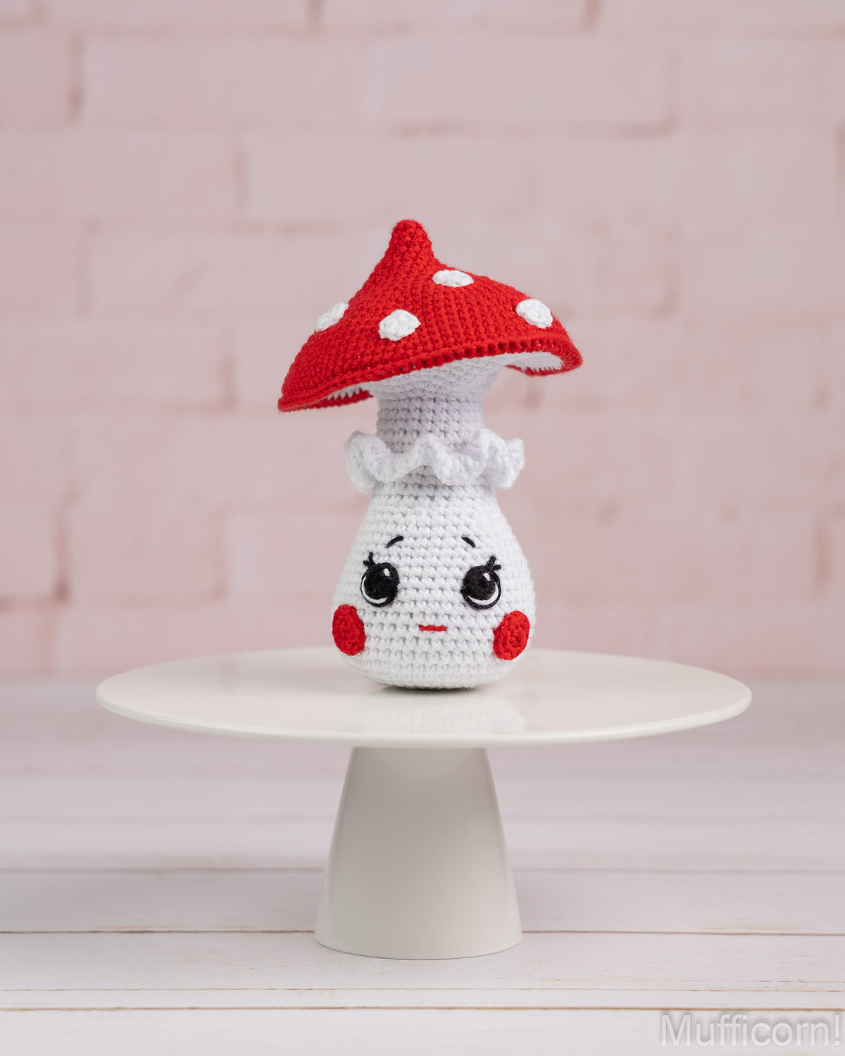 Crochet mushroom girl amigurumi standing on tray