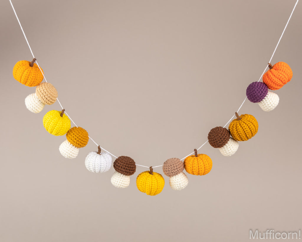 Crochet fall garland with pumpkins and mushrooms hanging on string