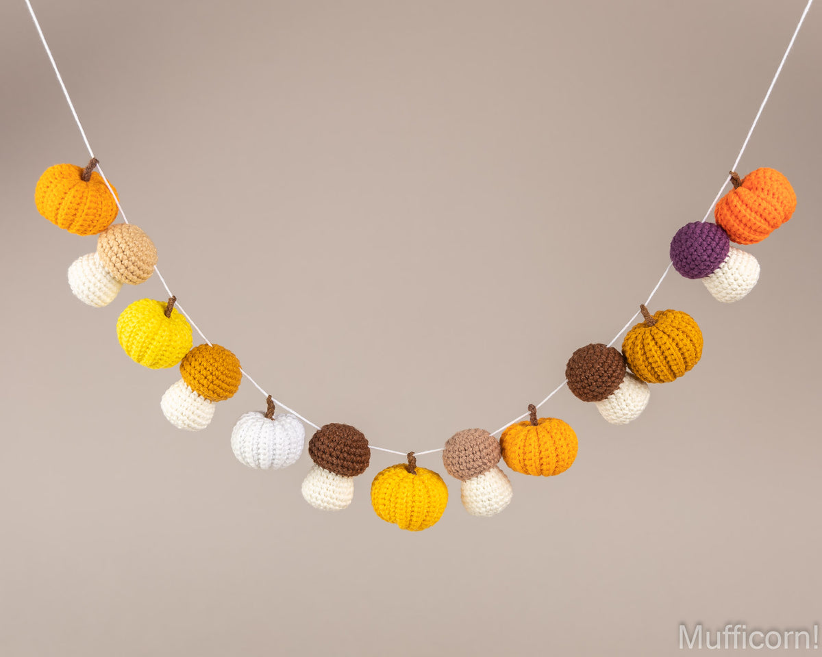 Crochet fall garland with pumpkins and mushrooms hanging on string