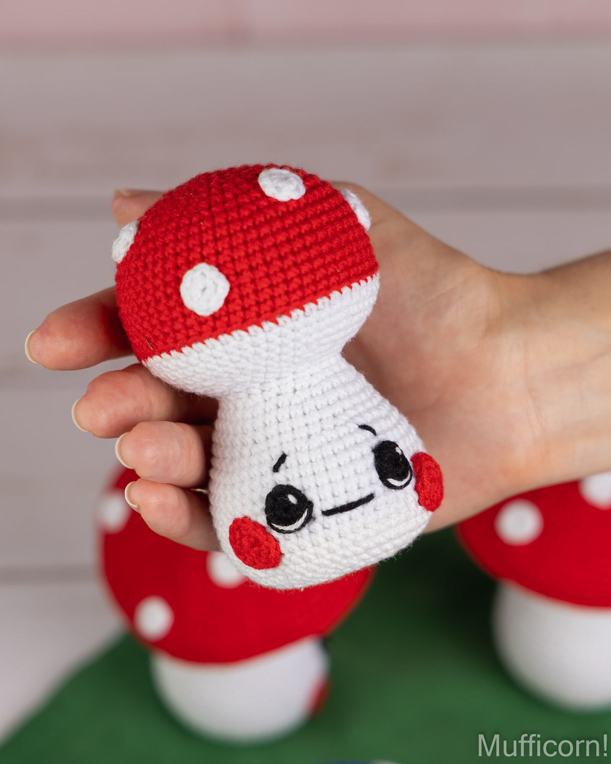 Mushroom baby crochet pattern held in hand