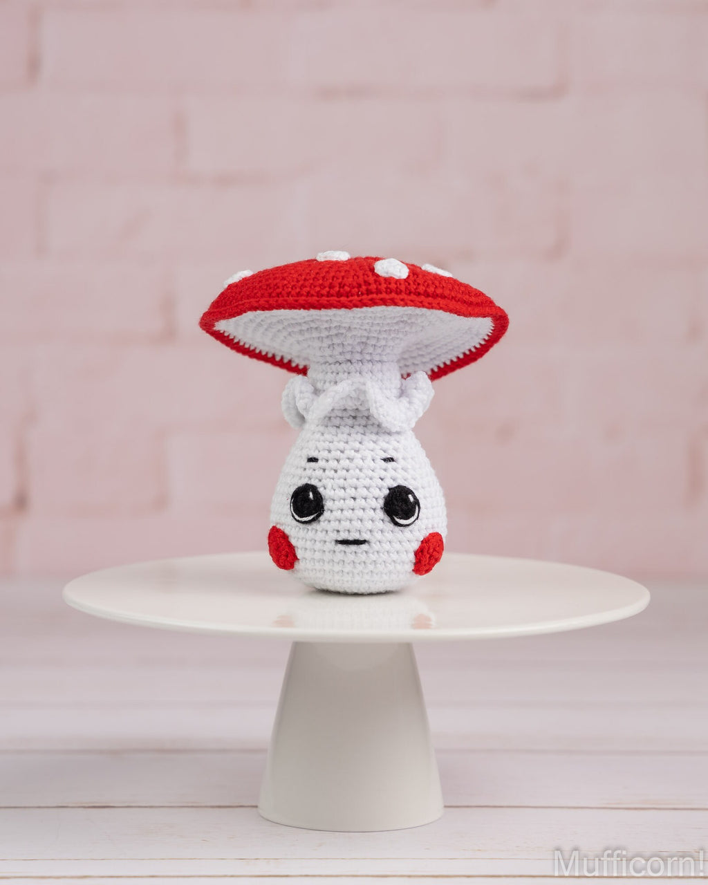 Crochet mushroom boy amigurumi standing on tray