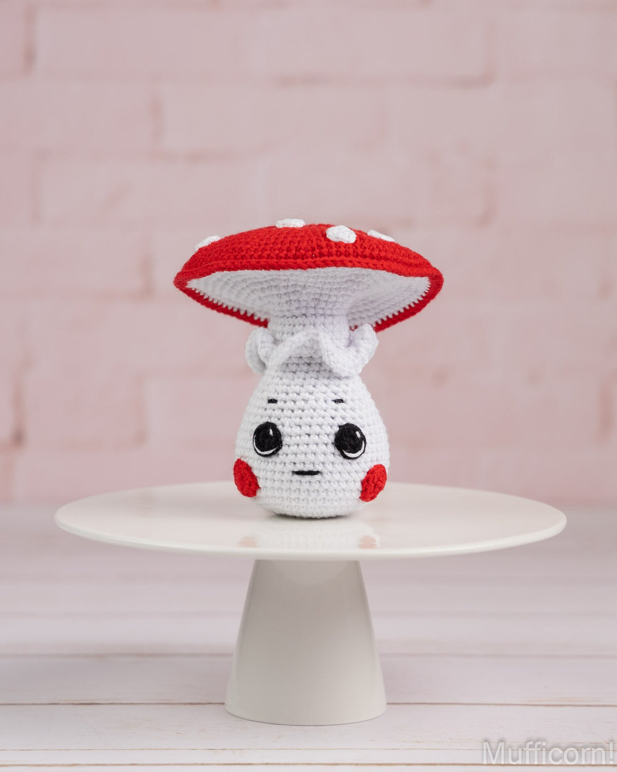 Crochet mushroom boy amigurumi standing on tray