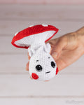 Mushroom boy crochet pattern held in hand