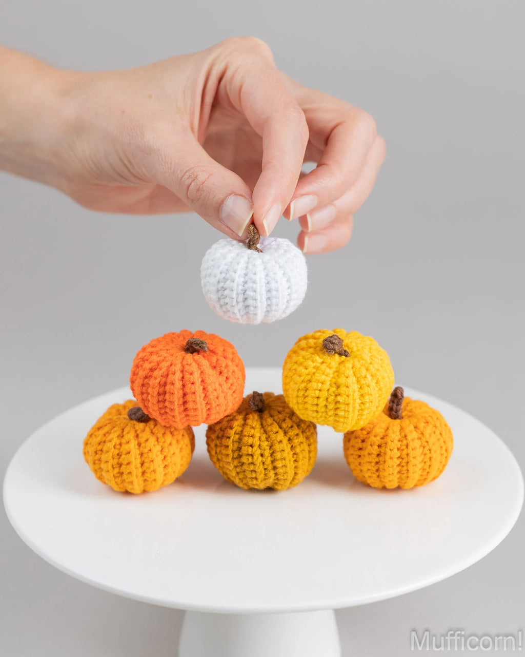 White crochet pumpkin held in hand