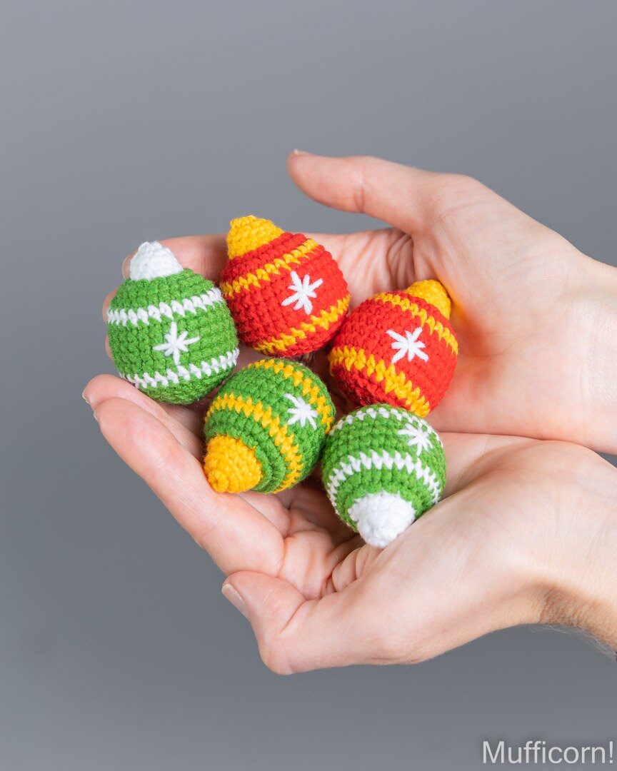 Crochet Christmas ball ornaments close-up in hand