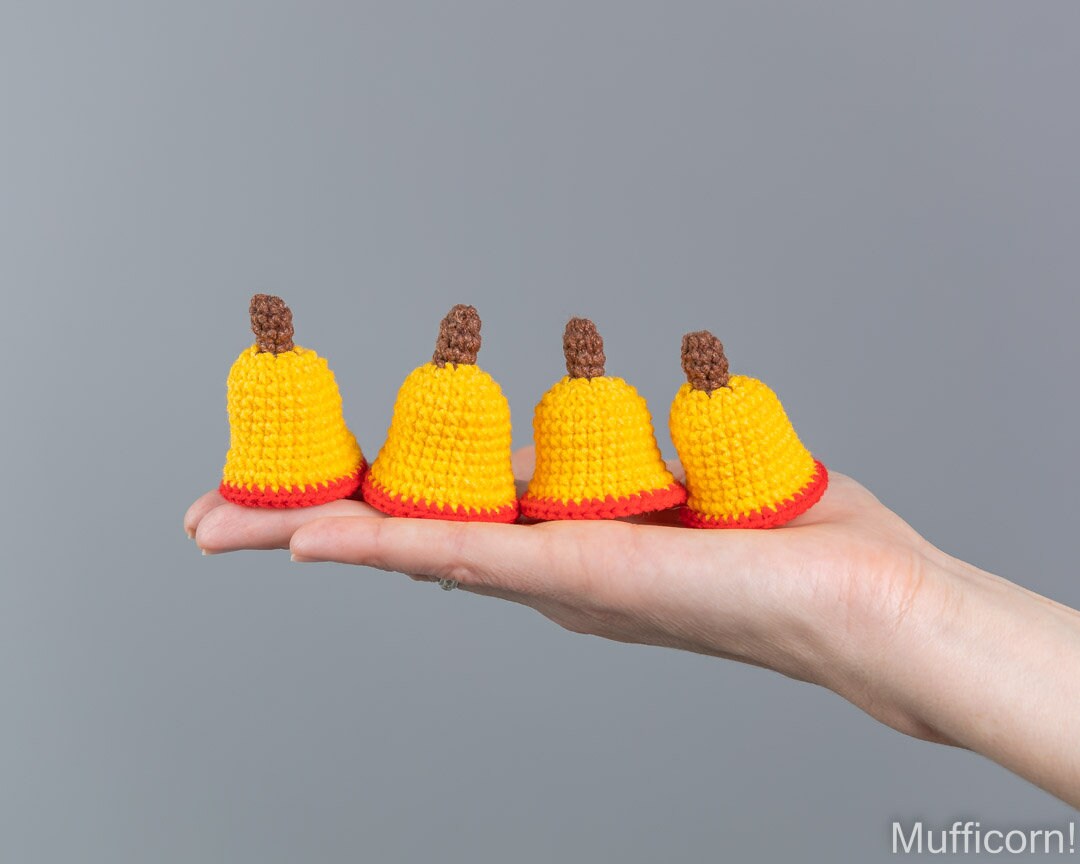 Crochet Christmas be;l ornaments close-up in hand