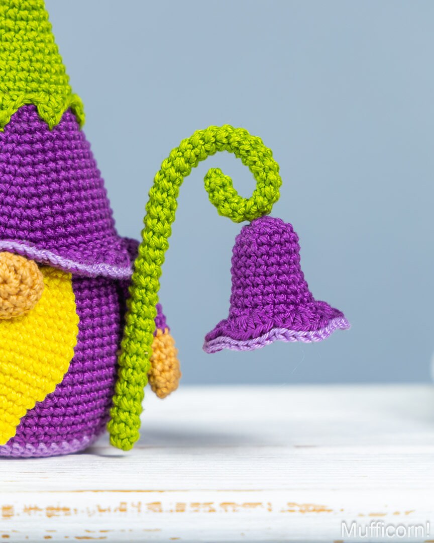 Crochet campanula flower detail held by gnome