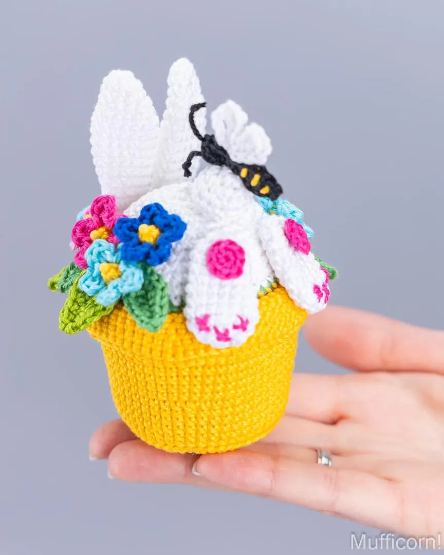 Crochet bunny in pot held in hand