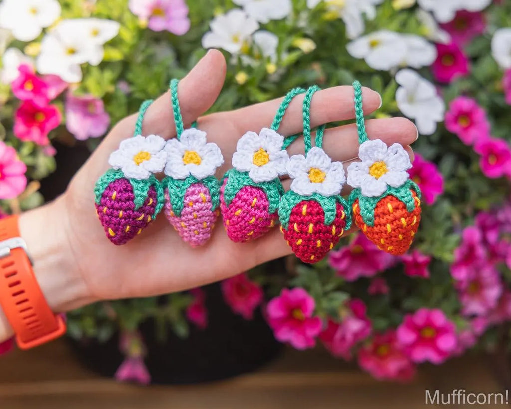 Crochet strawberry keychain hanging in hand