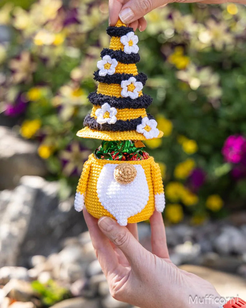 Bee gnome candy keeper held in hand showing candy storage in garden