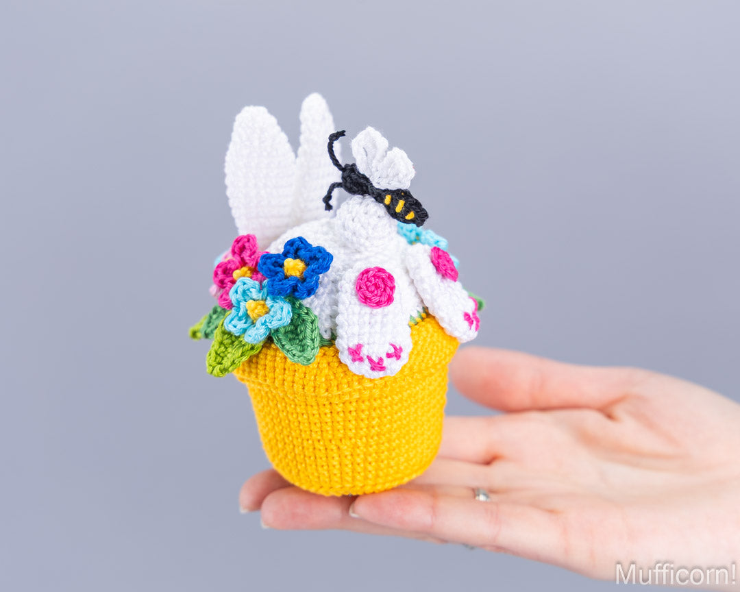 Crochet bunny in a pot held in hand