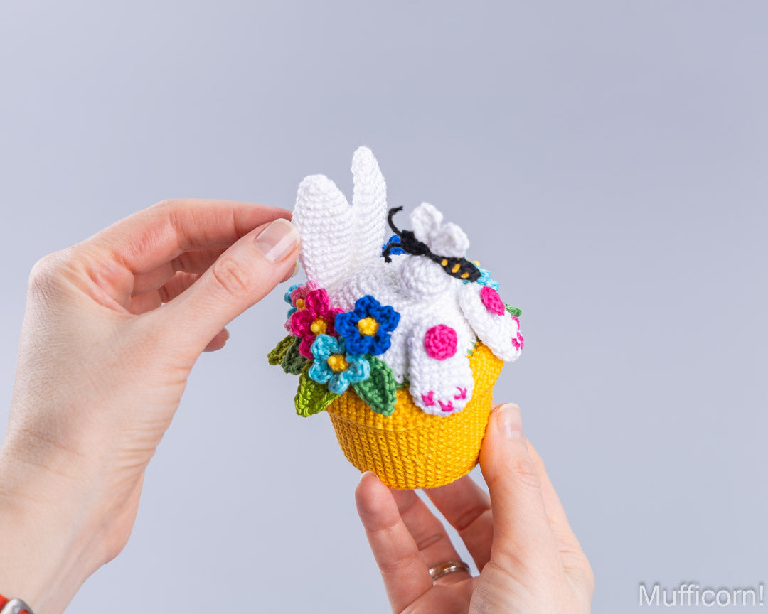 Crochet bunny in pot held in two hands