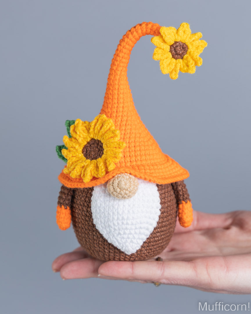 Sunflower gnome crochet pattern held in hand